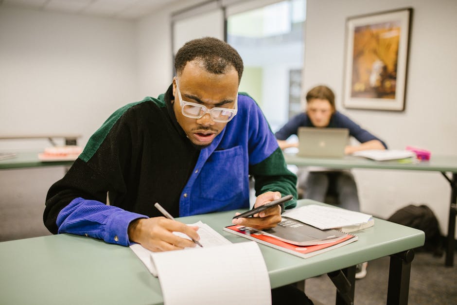 College students focused on a test in a classroom, showcasing study and knowledge
